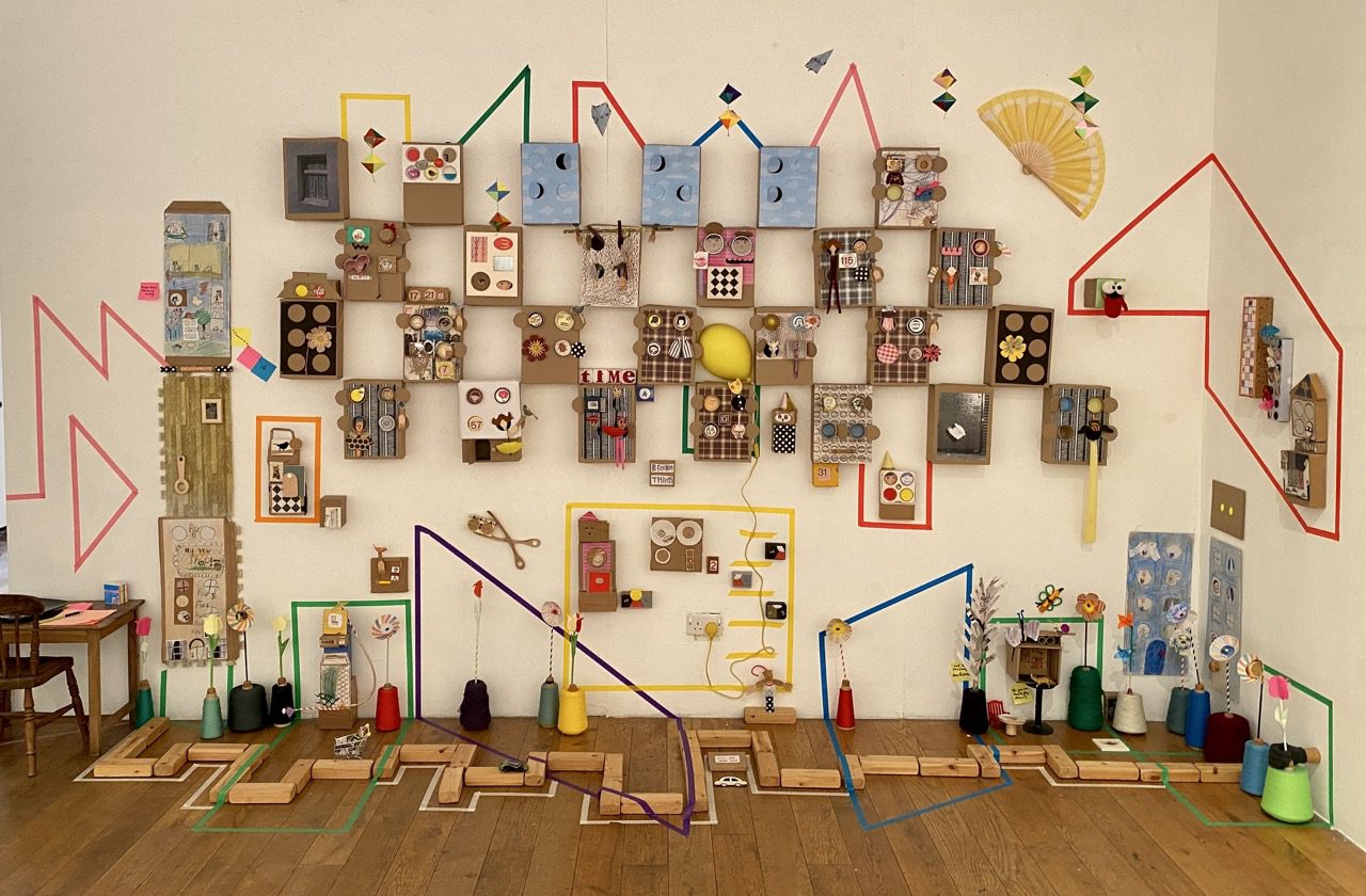 Children from Bethnal Green After School Club creating collective sculpture of miniature houses with artist Charlotte Mew at ELF Festival of Creative Health