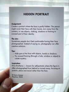 Close-up of illustrated game cards from the Creative Health Photo Game on the booth table